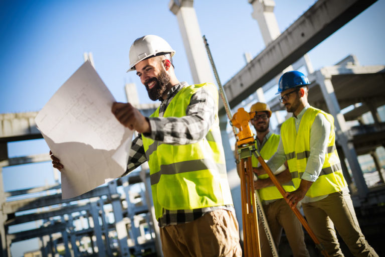 Portrait of construction engineers working on building site